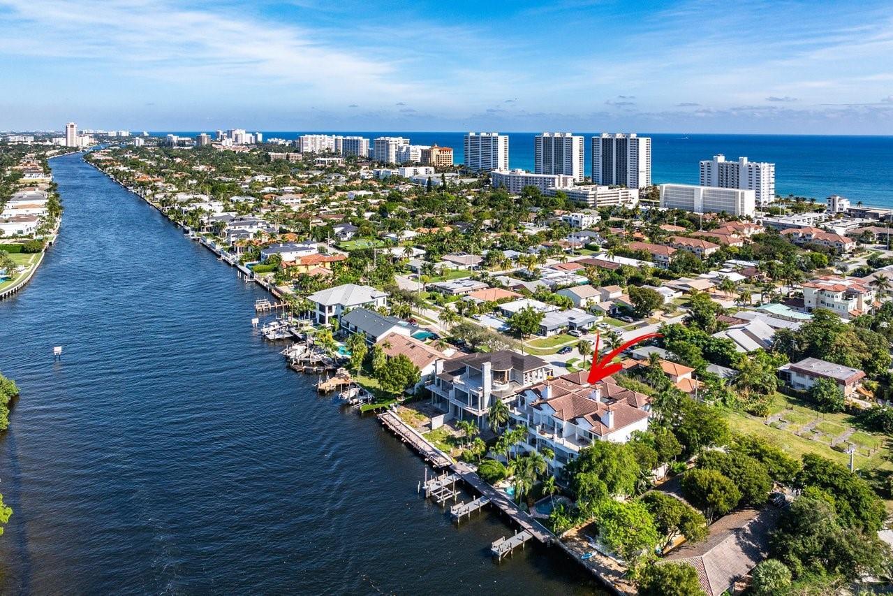 An aerial view of a multi-story waterfront home with a dock along a canal — 549 NE 19th Avenue # C, Deerfield Beach FL 33441, DEERFIELD BEACH, FL