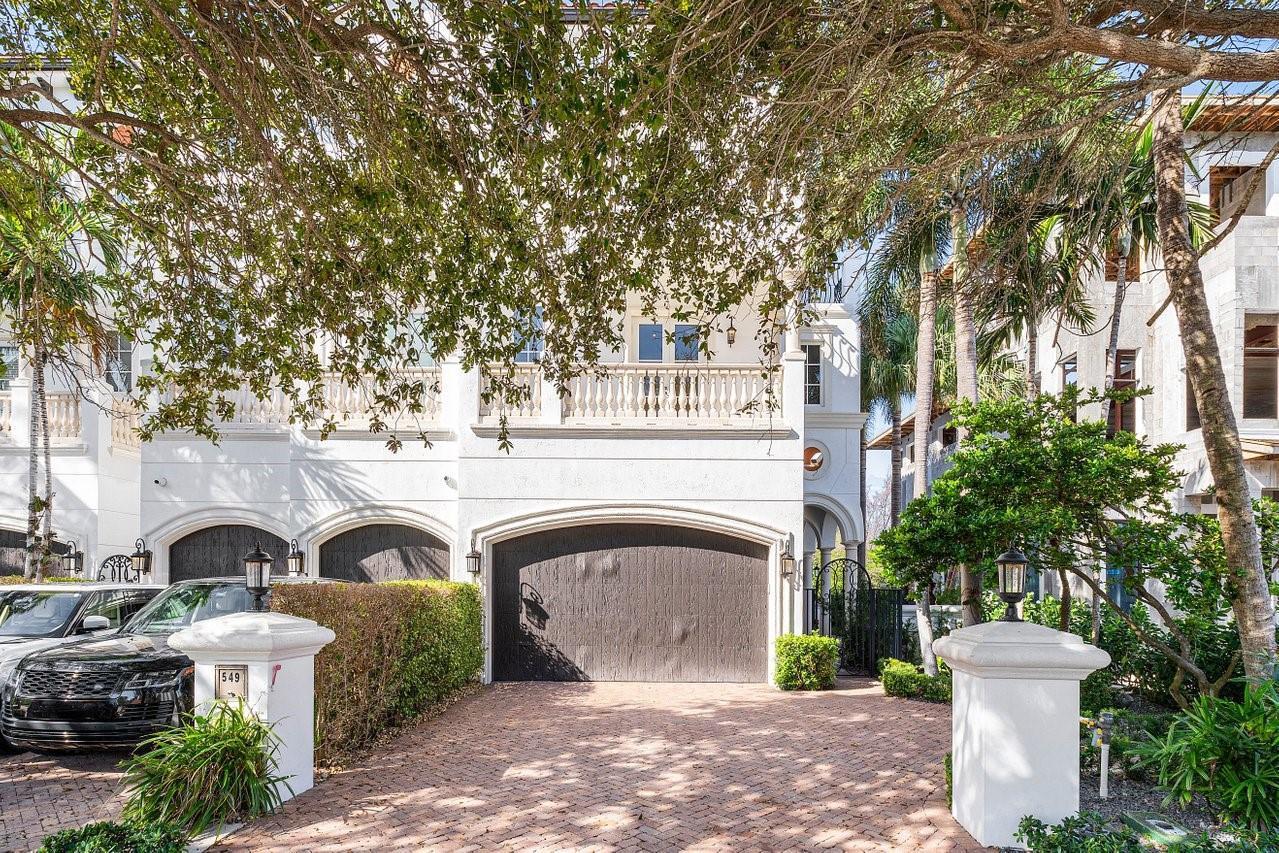 A white multi-story house with a brick driveway, a dark garage door, and a balcony — 549 NE 19th Avenue # C, Deerfield Beach FL 33441, DEERFIELD BEACH, FL