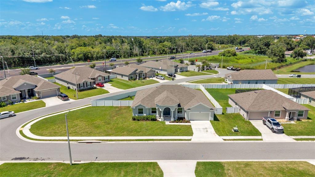 An aerial view of a suburban neighborhood featuring several single-family homes with fenced backyards — 283 COVE AT EAGLE LAKE CIRCLE, EAGLE LAKE, FL