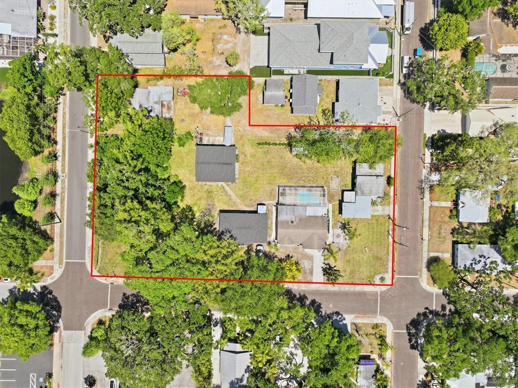 This aerial view shows a residential property lot outlined in red with multiple structures — 2ND STREET N, SAFETY HARBOR, FL