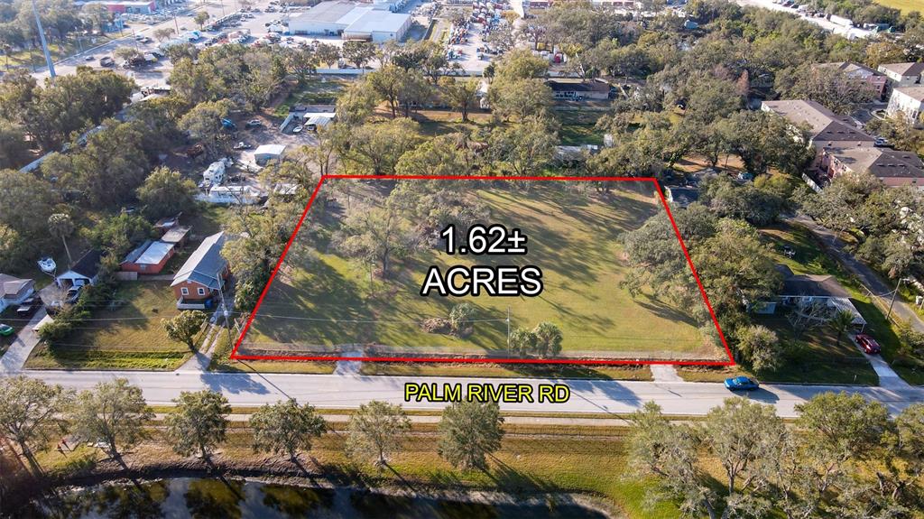 An aerial view shows a rectangular plot of land outlined in red along a road — 4811 PALM RIVER ROAD, TAMPA, FL