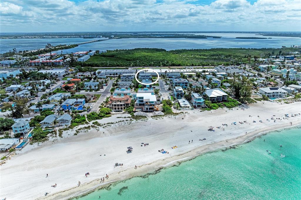 An aerial view of a coastal beach town with a white circle highlighting a building — 3400 6TH AVENUE UNIT 6, HOLMES BEACH, FL