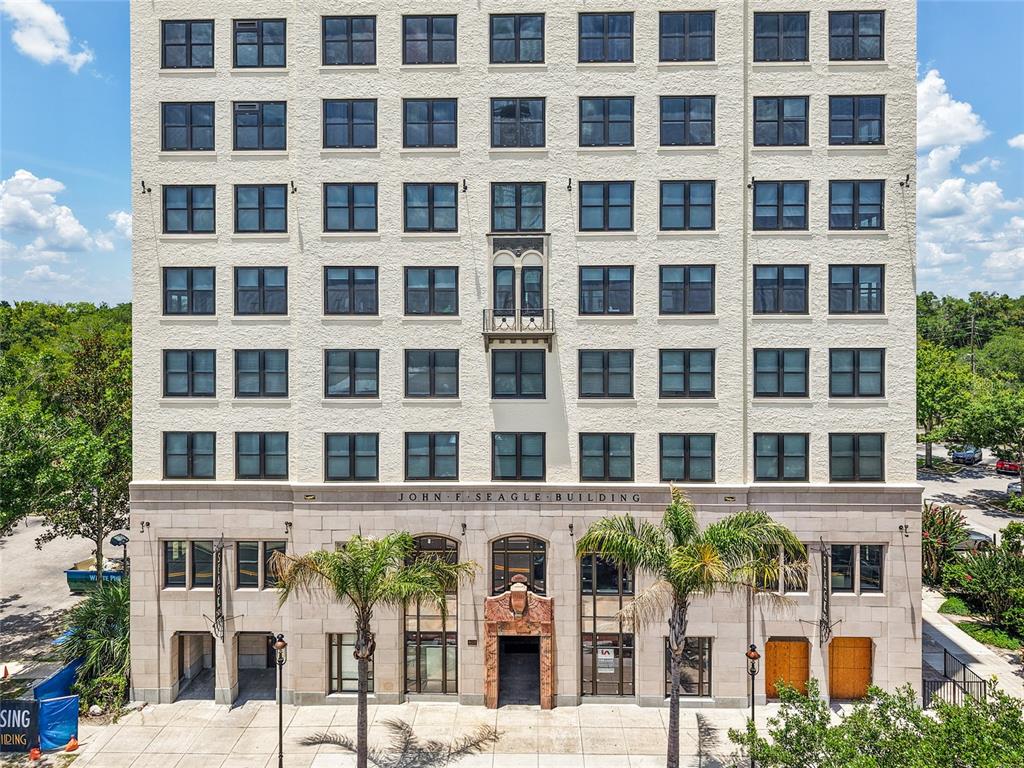 The exterior of the multi-story John F. Seagle Building features a stone facade and palm trees — 408 W UNIVERSITY AVENUE UNIT 7B, GAINESVILLE, FL