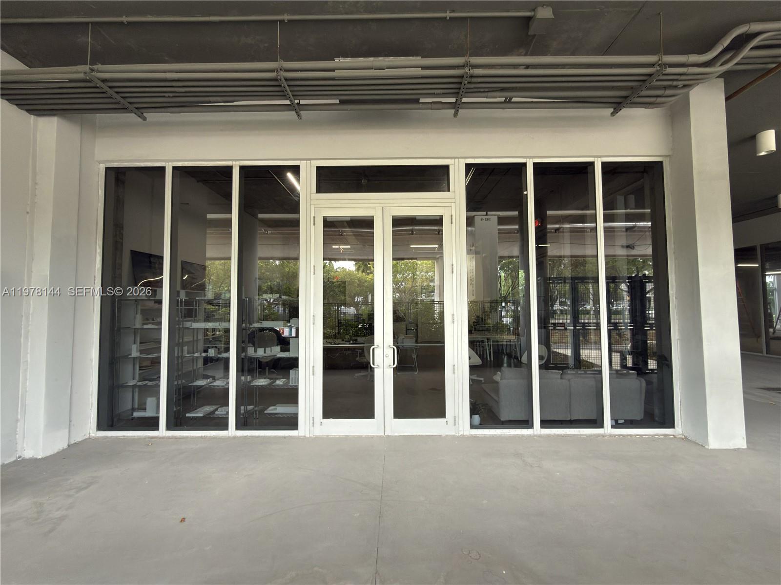 The exterior view shows a commercial storefront with glass double doors and large windows — 2900 SW 28th Ln # C5, Miami FL 33133, MIAMI, FL