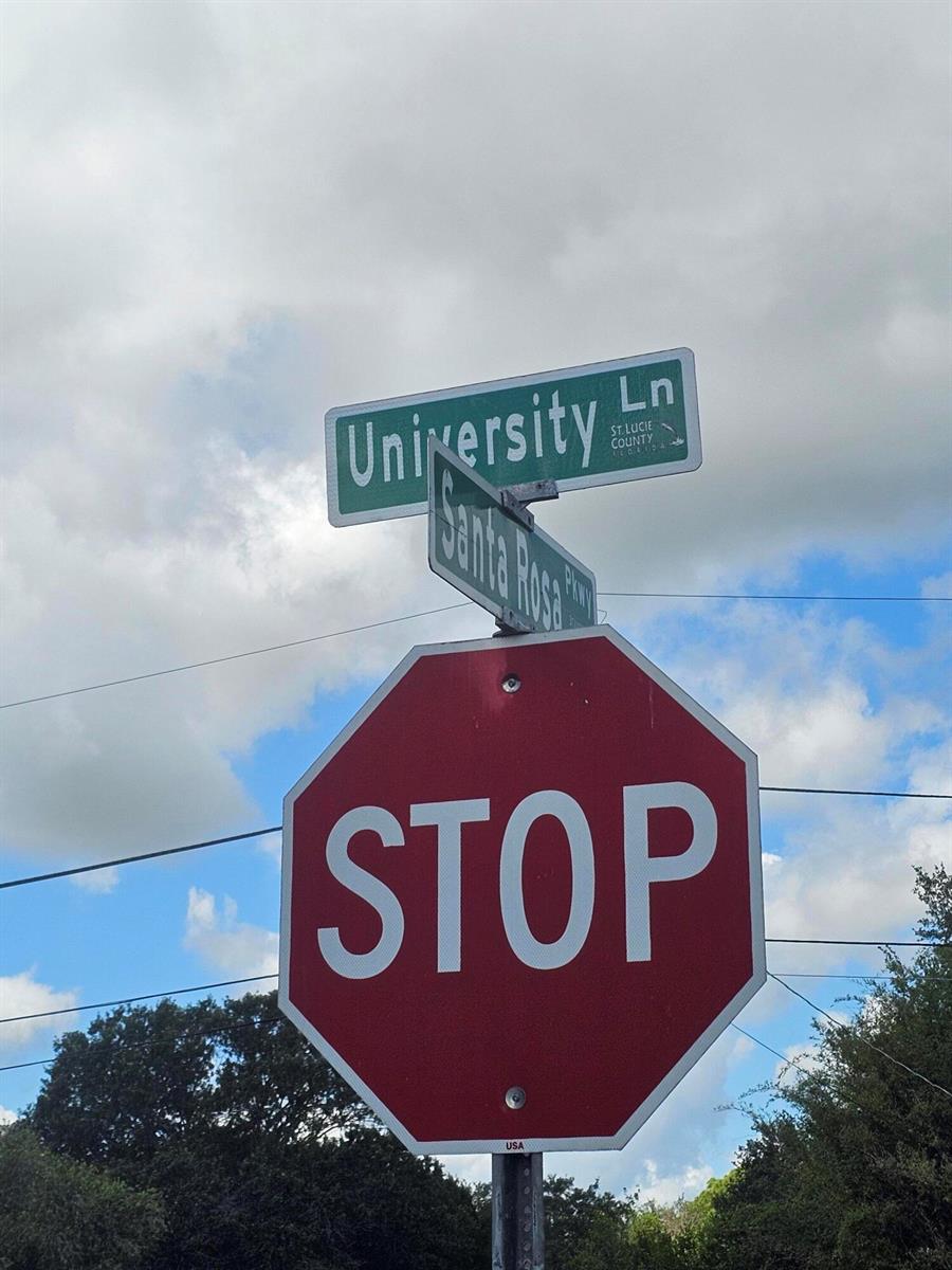 A stop sign stands below street signs for University Lane and Santa Rosa Parkway — 5707 University Lane, Fort Pierce FL 34951, FORT PIERCE, FL