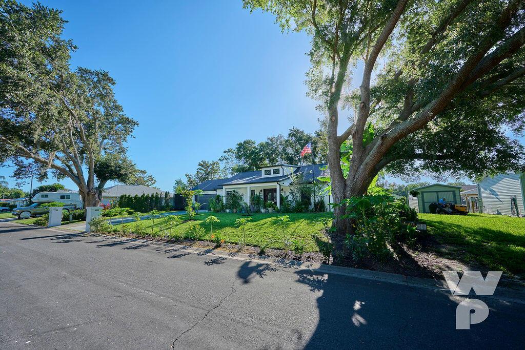A single-story house with a white exterior, a front porch, and a large front yard — 441 Spoonbill Court, FL 34739, FL