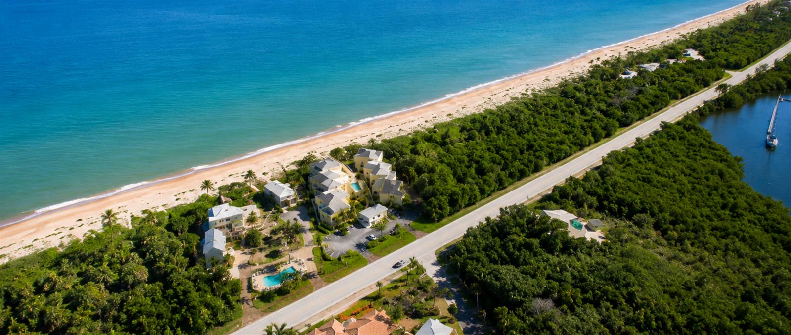 An aerial view shows a beachside resort complex nestled between the ocean and a road — 3541 NE Ocean Boulevard # 4, Jensen Beach FL 34957, JENSEN BEACH, FL