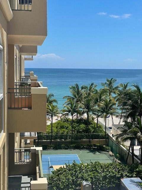 A view from a balcony overlooking a tennis court, palm trees, and the ocean — 2080 S Ocean Drive # 505, Hallandale Beach FL 33009, HALLANDALE BEACH, FL