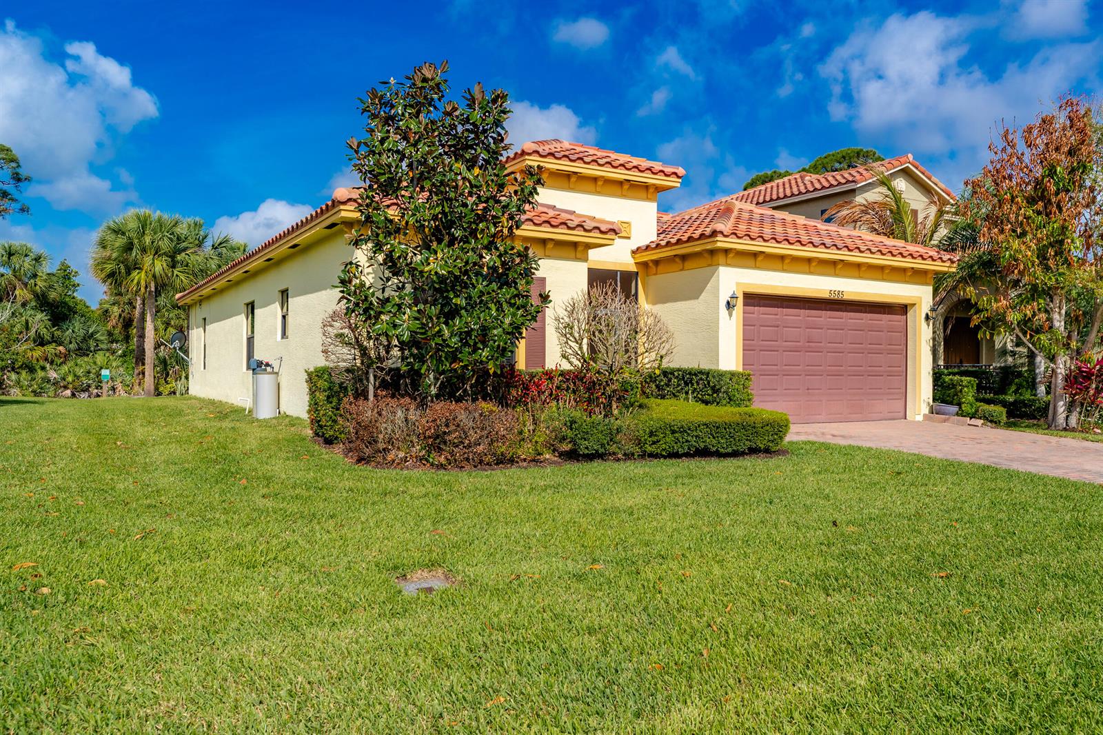 A single-story yellow house with a brown garage door and a red tile roof — 5585 40th Avenue, Vero Beach FL 32967, VERO BEACH, FL