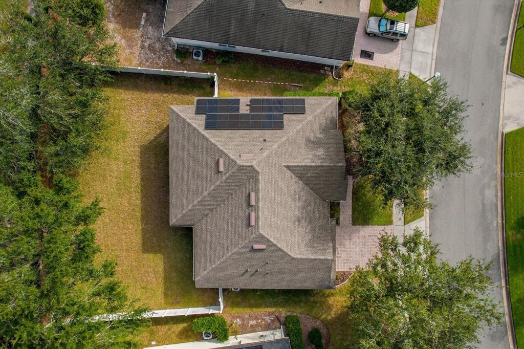 An aerial view shows a house with solar panels on the roof and a fenced yard — 2284 PICKFORD CIRCLE, APOPKA, FL