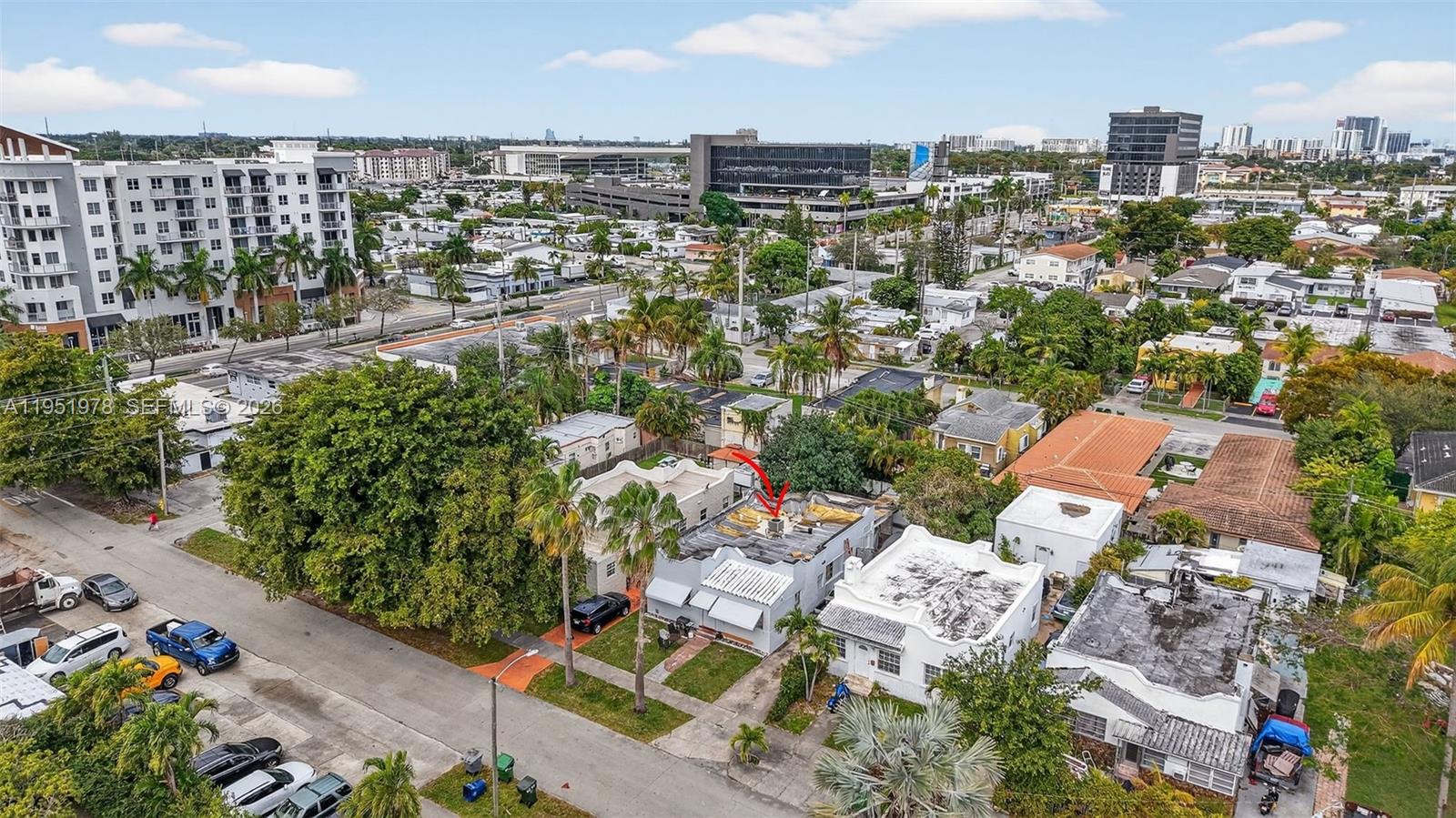 An aerial view shows a residential street with a house featuring a damaged flat roof — 623 NE 4th St, Hallandale Beach FL 33009, HALLANDALE BEACH, FL