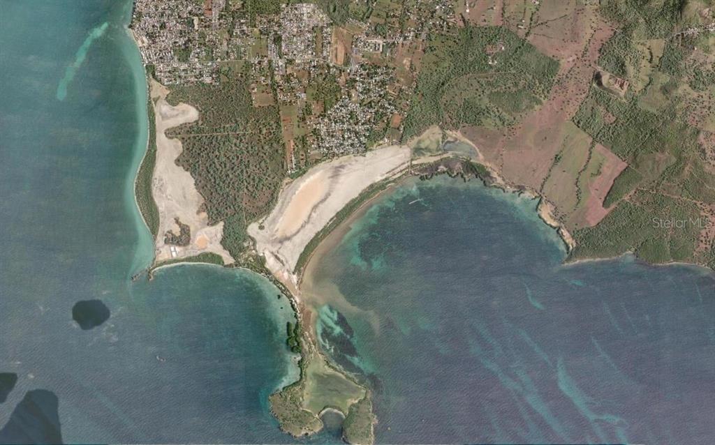 An aerial view shows a gated entrance leading to a long, undeveloped dirt road — SR 301 km 9.9 int SECTOR LAS SALINAS BARRIO BOQUERON UNIT D-2, CABO ROJO, PR