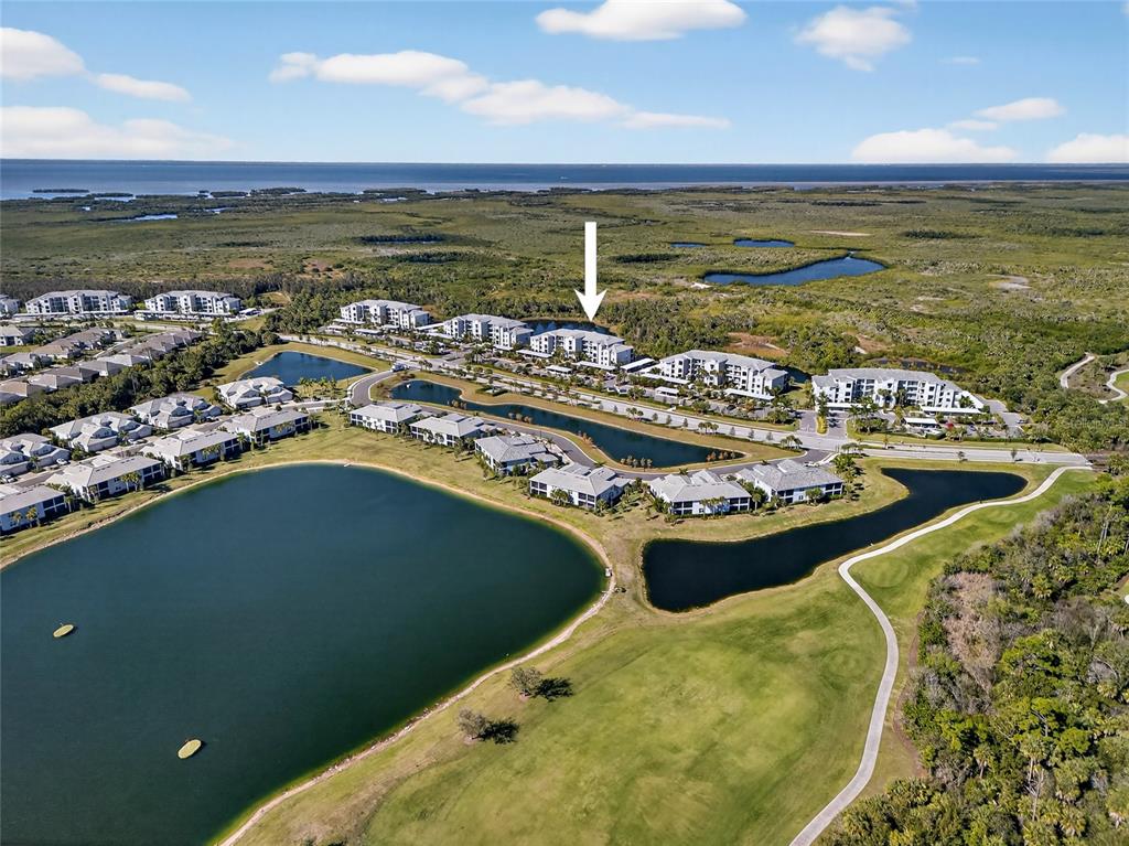 An aerial view shows a residential apartment complex surrounded by ponds and green space — 14141 HERITAGE LANDING BOULEVARD UNIT 934, PUNTA GORDA, FL