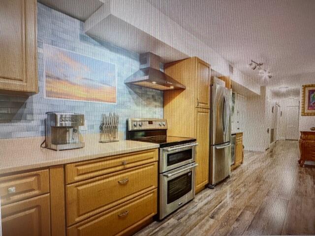 A kitchen features light wood cabinets, stainless steel appliances, and a blue tiled backsplash — 300 N Highway A1a # 204a, Jupiter FL 33477, JUPITER, FL
