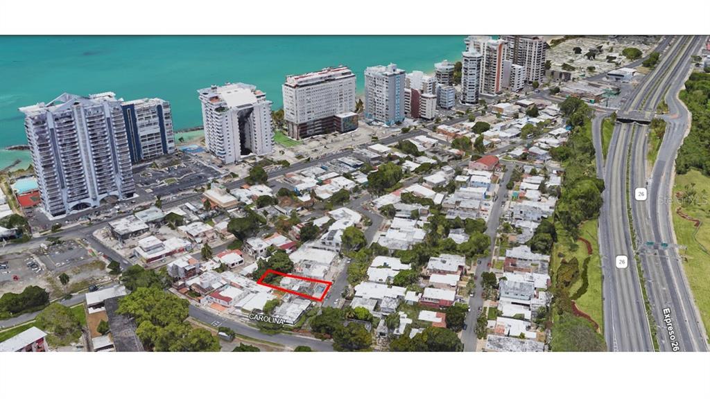 An aerial view shows a residential neighborhood near the coast with a highlighted property lot — Atlantic View ISLA VERDE, CAROLINA, PR