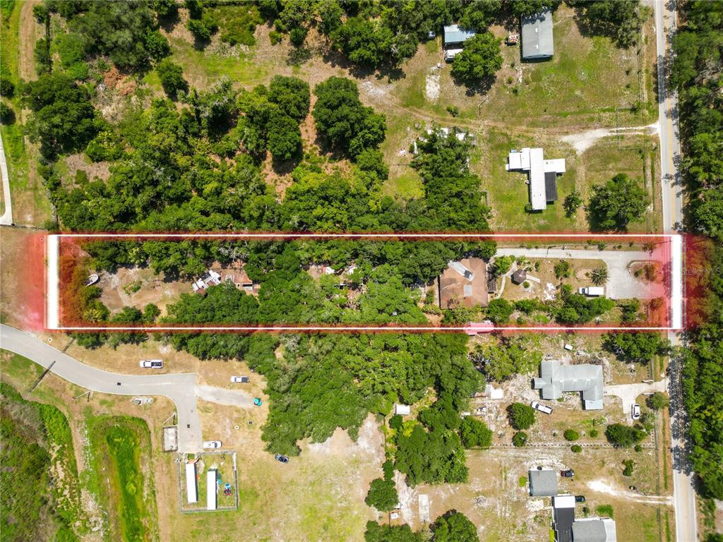 An aerial view shows a rectangular property lot outlined in red, featuring trees and buildings — 4125 SWINDELL ROAD, LAKELAND, FL