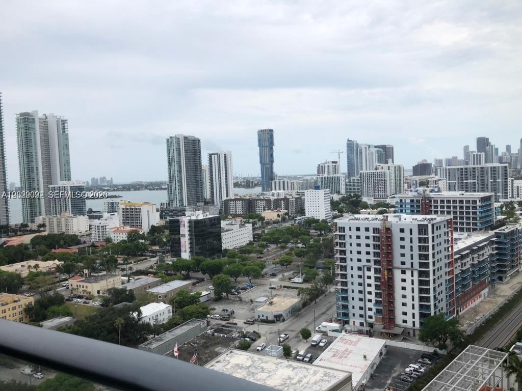 An elevated view of a city skyline featuring numerous high-rise buildings and urban streets — 121 NE 34th St # 2203, Miami FL 33137, MIAMI, FL