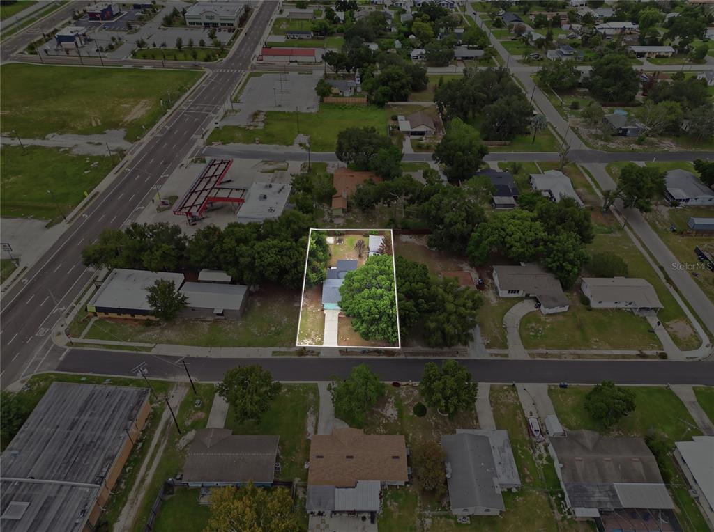 An aerial view shows a single-story house with a large tree on a residential lot — 120 E HOFFMAN ST, LAKE ALFRED, FL