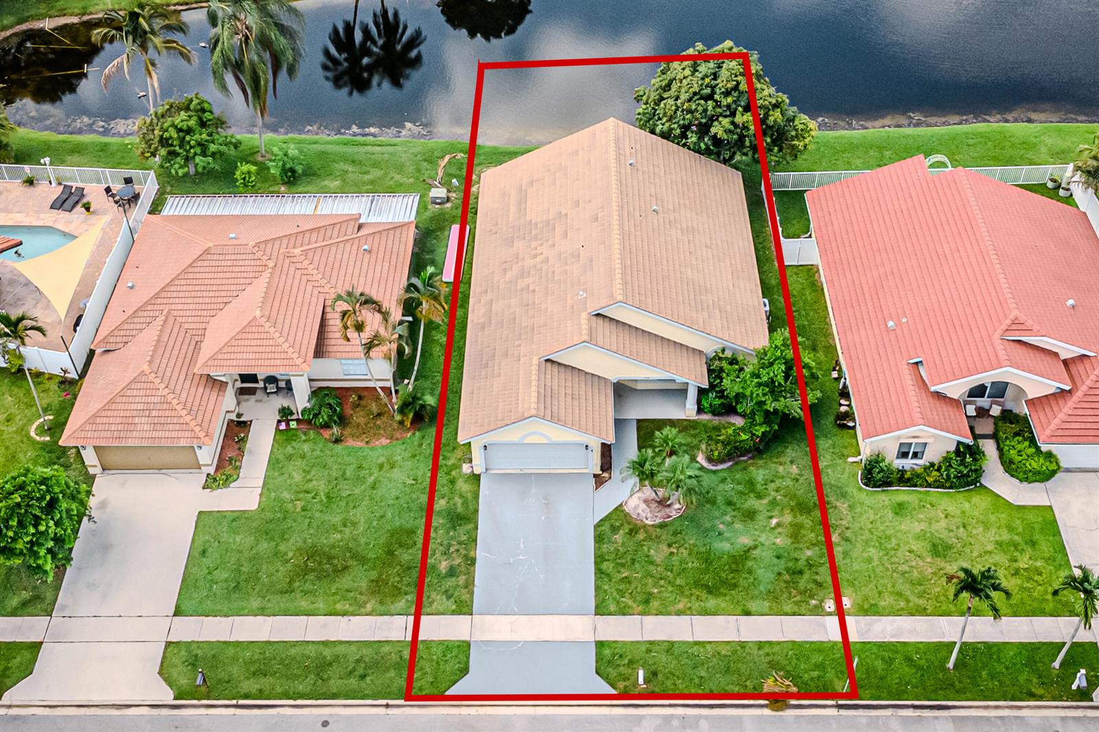 An aerial view shows a single-story house with a tan roof and driveway facing a street — 5148 Rosen Boulevard, Boynton Beach FL 33472, BOYNTON BEACH, FL