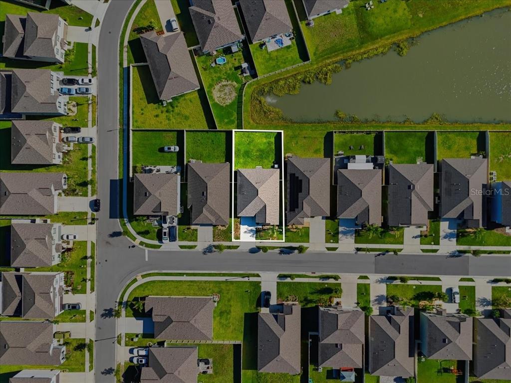 This aerial view shows a single-family home with a fenced backyard in a residential neighborhood — 4316 TROTTERS WAY, LAKELAND, FL
