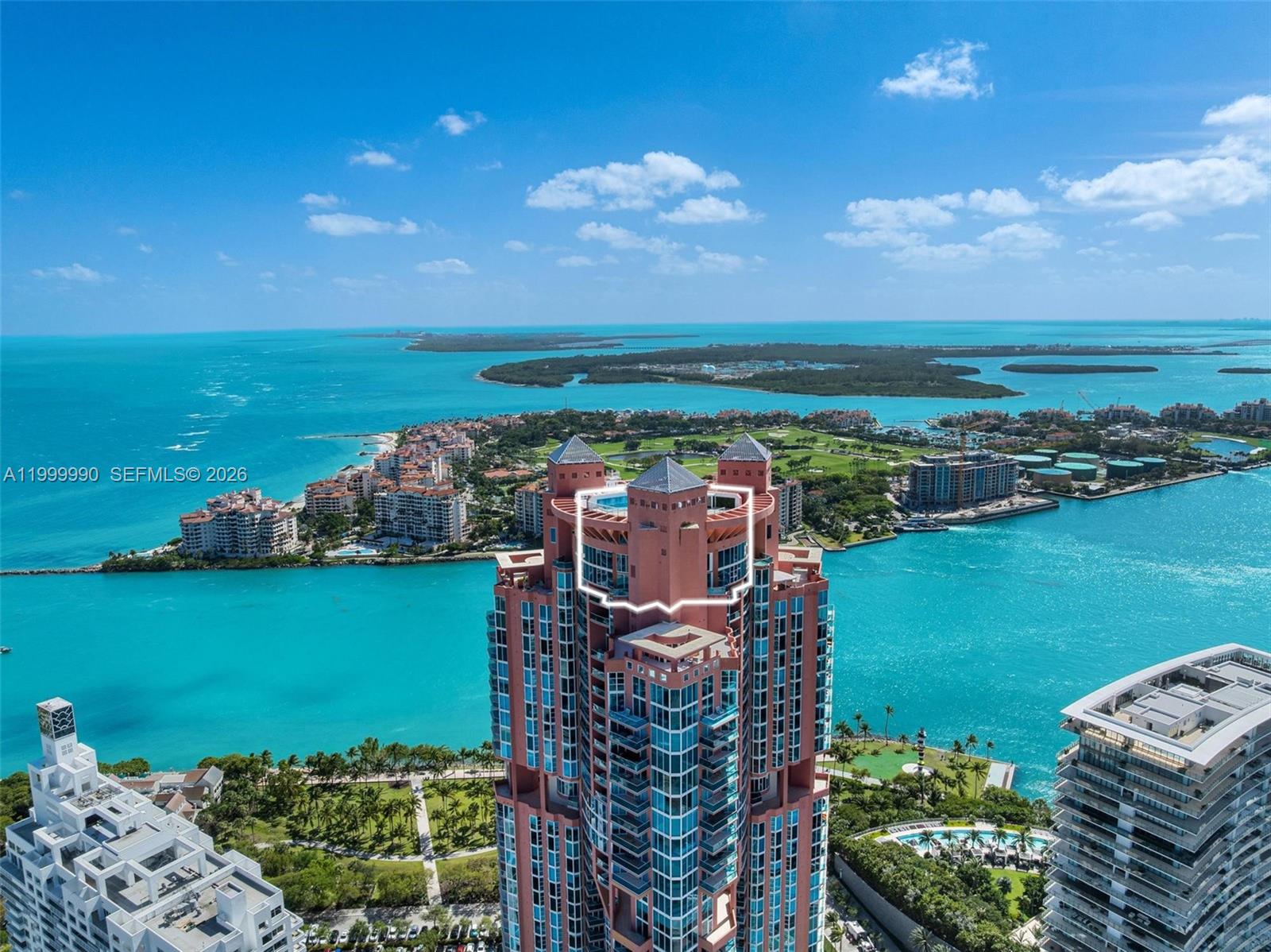 An aerial view shows the top floors of a pink high-rise building by the water — 300 S Pointe Dr # 5, Miami Beach FL 33139, MIAMI BEACH, FL