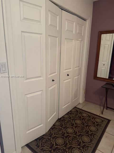 White bi-fold closet doors are positioned next to a mirror on a purple wall — 4299 NW 16th St # 103, Lauderhill FL 33313, LAUDERHILL, FL
