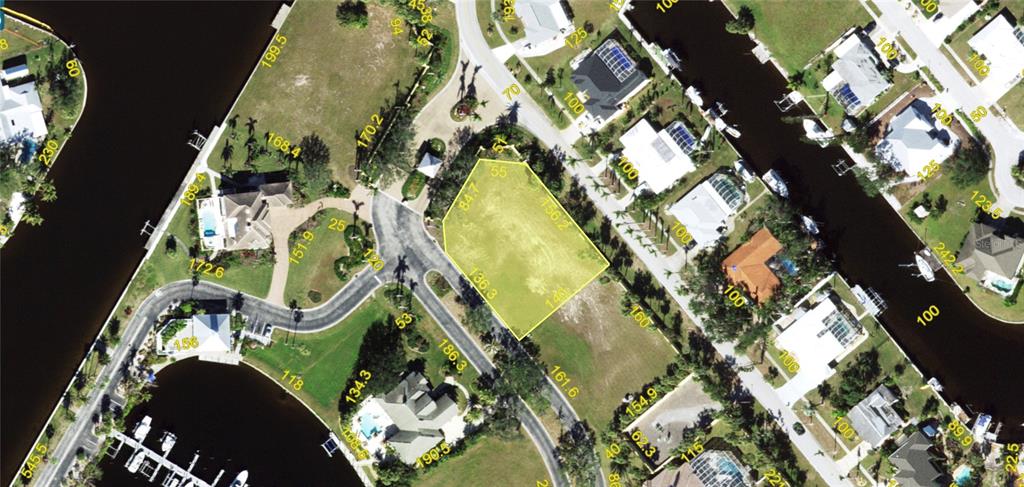 This is an aerial map showing a vacant residential lot highlighted in yellow — 4400 GRASSY POINT BOULEVARD, PORT CHARLOTTE, FL