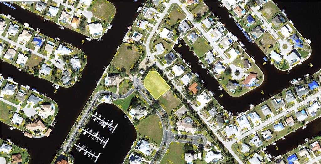 This is an aerial map showing a vacant lot highlighted in yellow within a residential neighborhood — 4400 GRASSY POINT BOULEVARD, PORT CHARLOTTE, FL