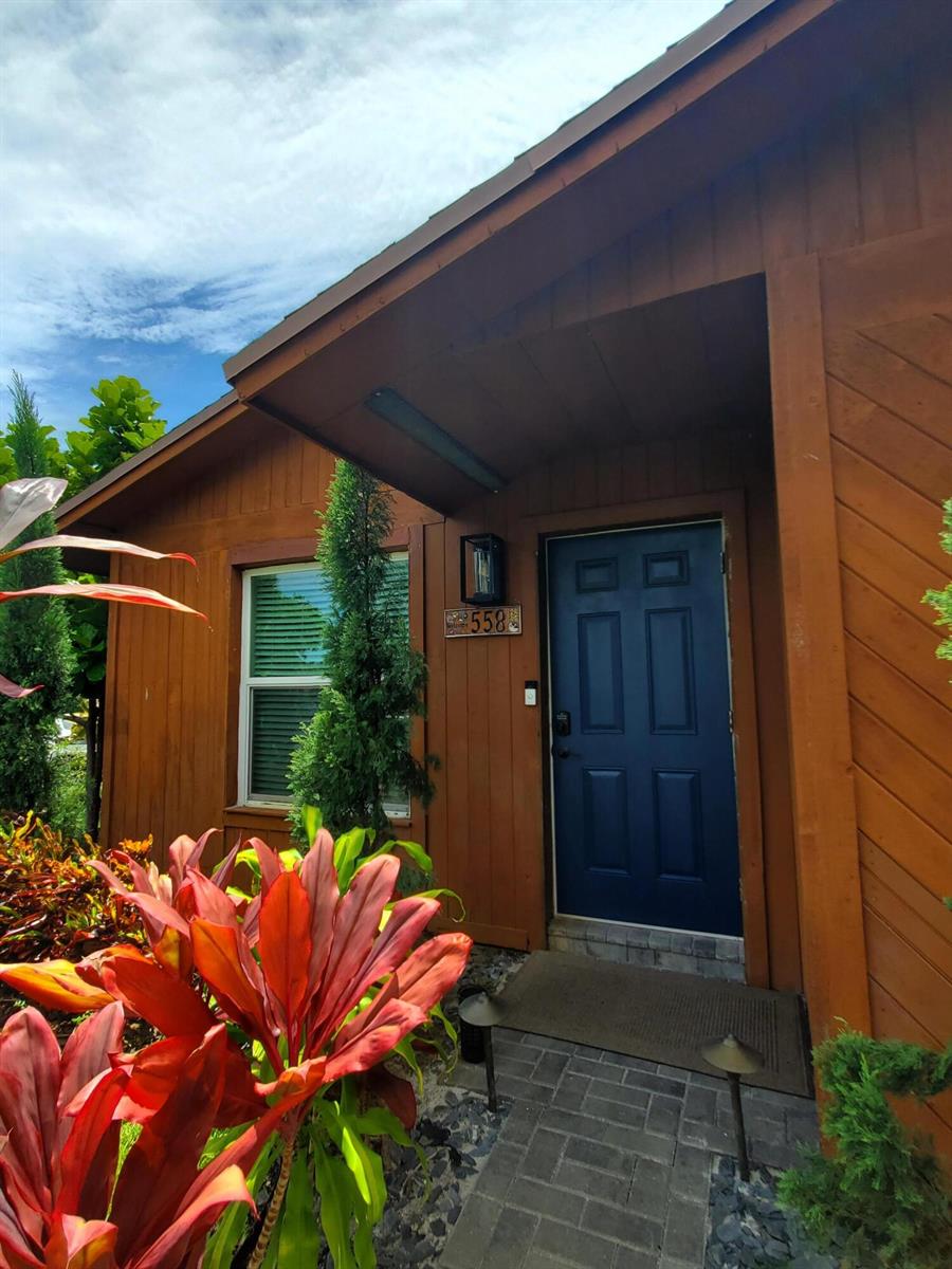 A blue front door with a house number is set into a brown wood-sided exterior — 558 SE 27th Terrace # 558, Boynton Beach FL 33435, BOYNTON BEACH, FL
