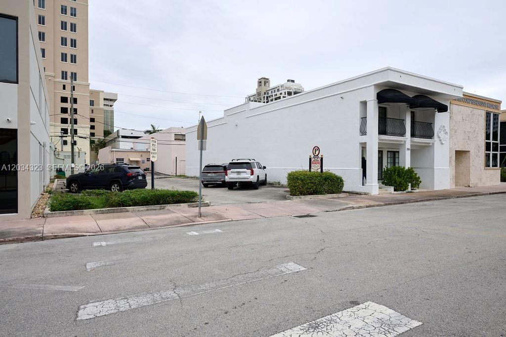 An exterior view of a white commercial building with a parking lot in front — 355 Palermo Ave, Coral Gables FL 33134, CORAL GABLES, FL