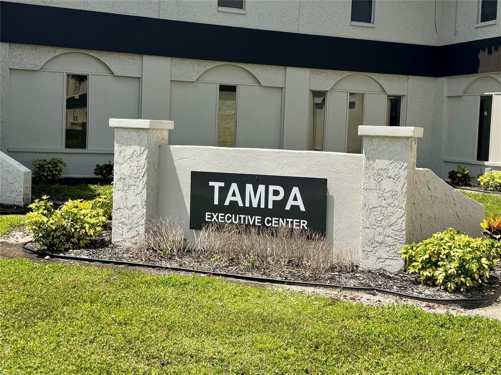 A sign for the Tampa Executive Center stands in front of a beige office building — 5118 N 56TH STREET UNIT 123, TAMPA, FL
