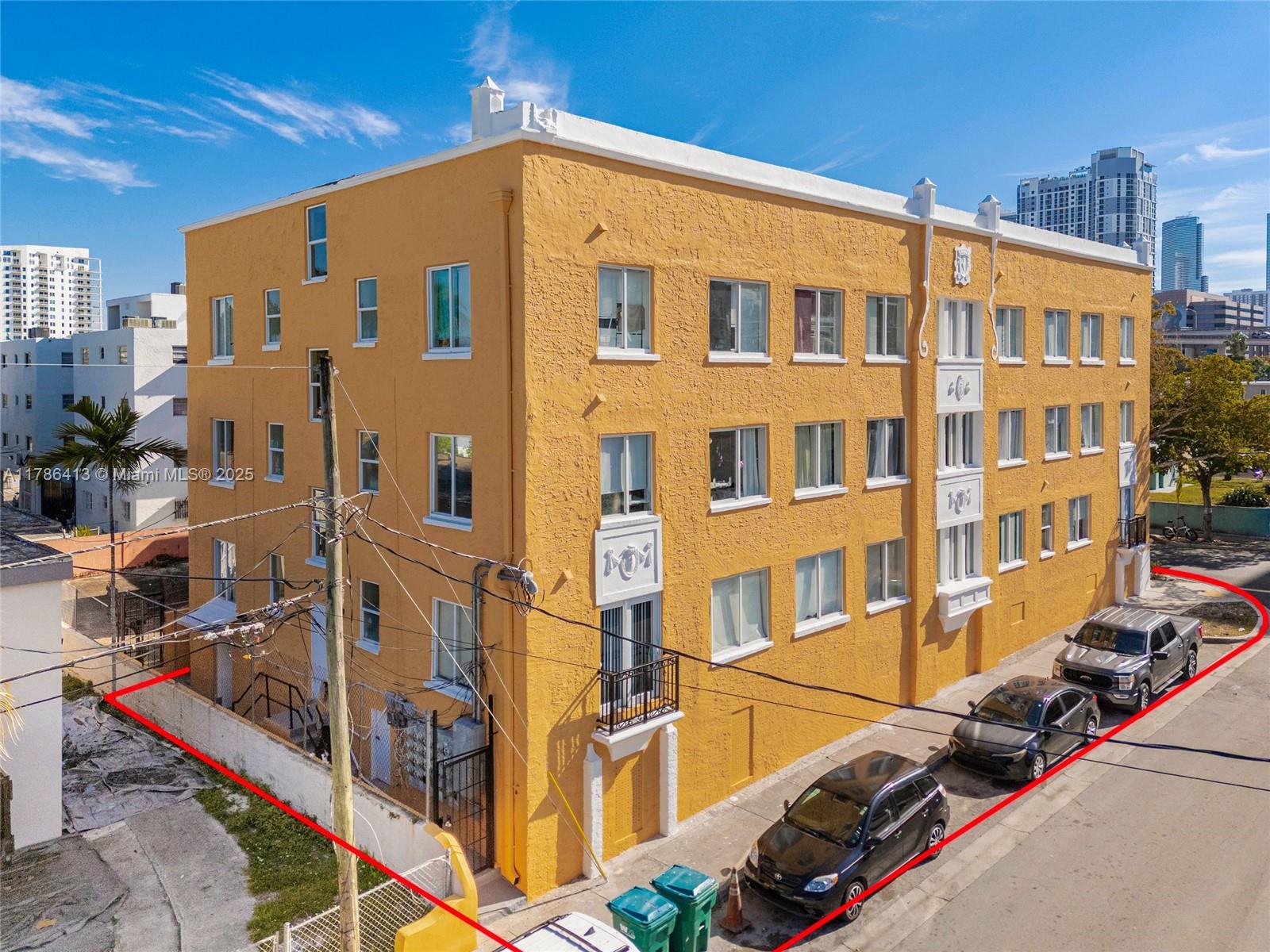 An exterior view of a three-story yellow apartment building with a red outline — 440 SW 5th Ave, Miami FL 33130, MIAMI, FL