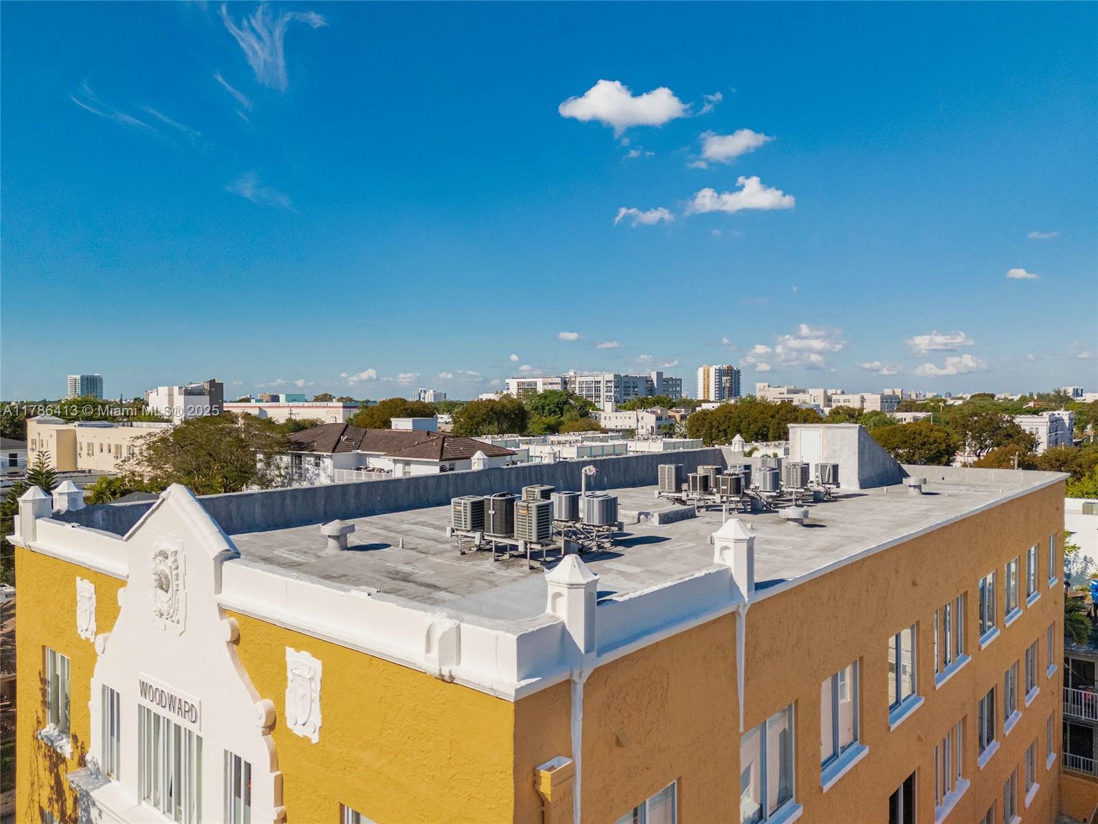 An aerial view of a yellow building roof with multiple air conditioning units — 440 SW 5th Ave, Miami FL 33130, MIAMI, FL