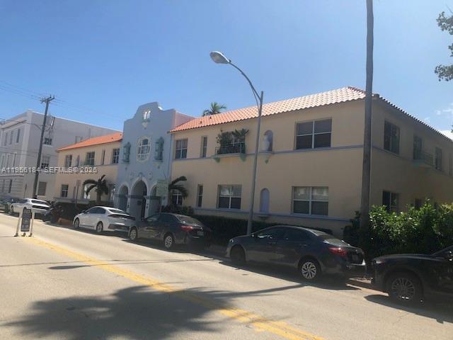 A two-story Mediterranean-style apartment building features a central arched entryway and street-side parking — 736 13th St # 202, Miami Beach FL 33139, MIAMI BEACH, FL