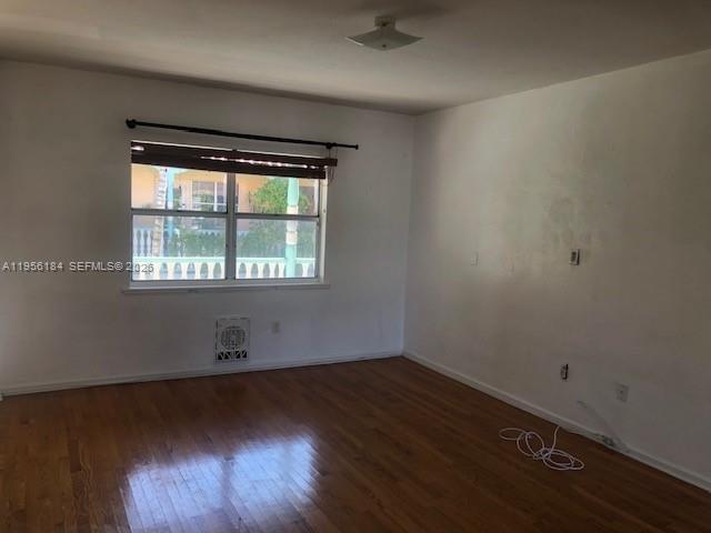 An empty room features hardwood floors, white walls, and a window with a curtain rod — 736 13th St # 202, Miami Beach FL 33139, MIAMI BEACH, FL