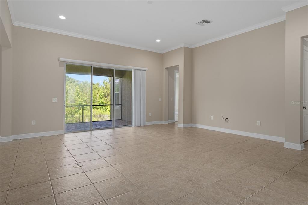 A kitchen featuring wood cabinets, granite countertops, stainless steel appliances, and tile flooring — 4551 SOUTHERN VALLEY LOOP, BROOKSVILLE, FL