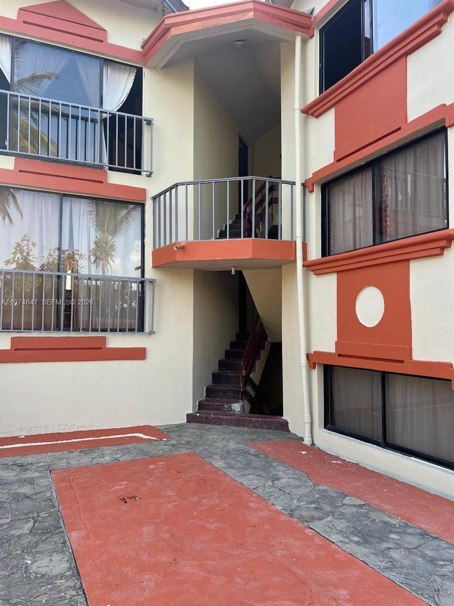 An exterior view of a multi-story apartment building with balconies and an outdoor staircase — No.10 Calle Bohechio, DR foreign, DR