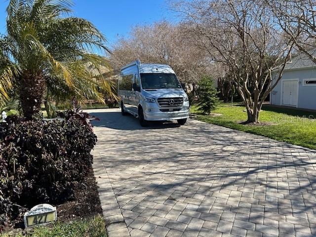 A silver Mercedes-Benz van is parked on a paved driveway in front of a house — 427 TRAVELERS DRIVE, POLK CITY, FL