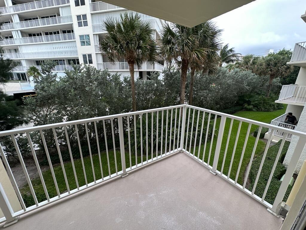 A bathroom features a glass-enclosed shower, a toilet, and a wooden vanity with granite countertops — 3540 S Ocean Boulevard # 208, South Palm Beach FL 33480, SOUTH PALM BEACH, FL