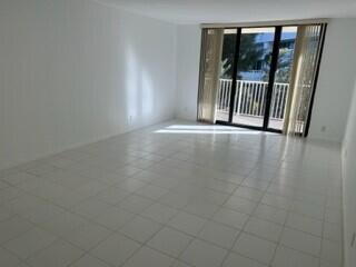 A bathroom features a white toilet, a bathtub with a shower, and a tan towel — 3540 S Ocean Boulevard # 208, South Palm Beach FL 33480, SOUTH PALM BEACH, FL