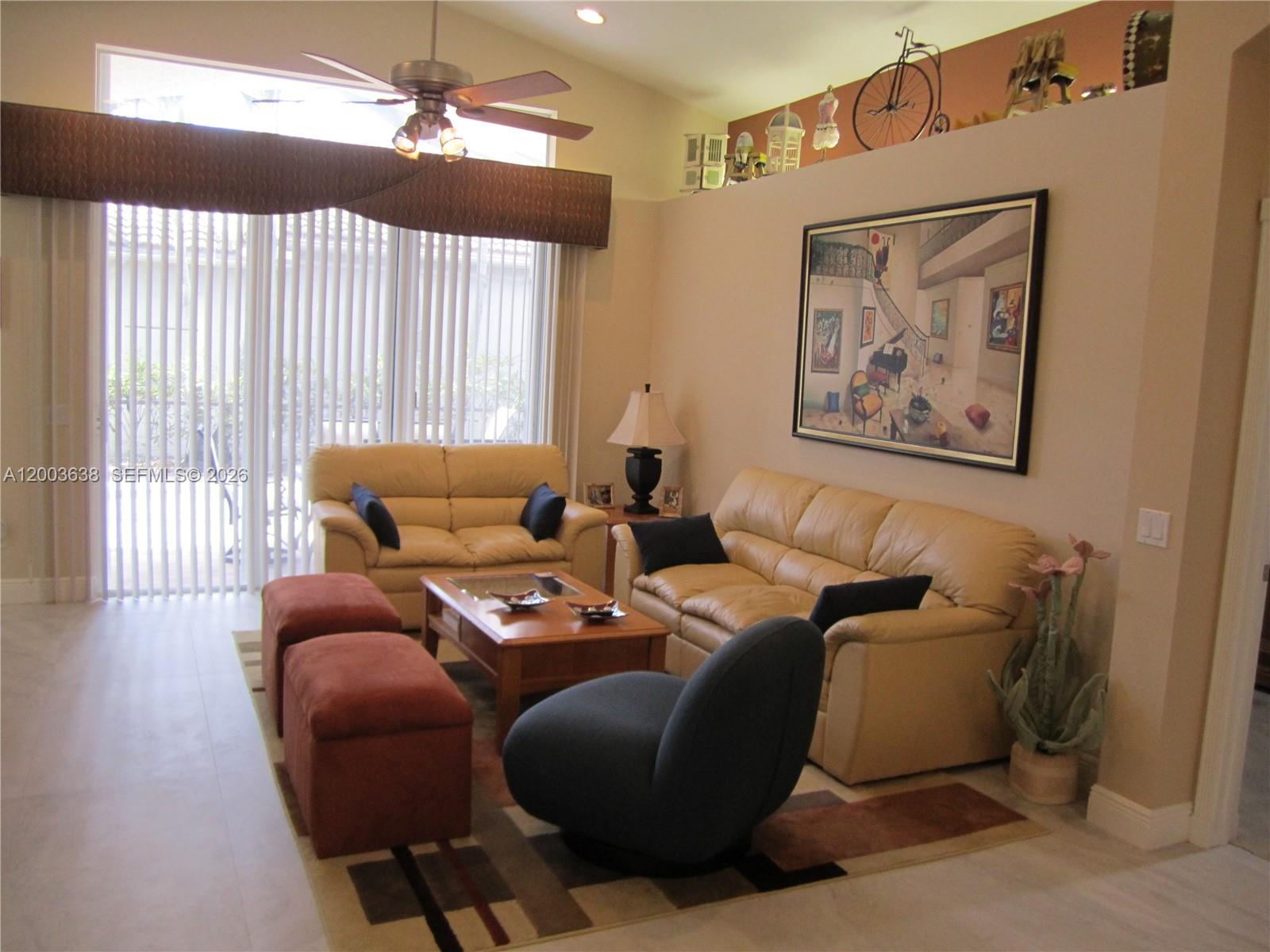 A living room features two tan leather sofas, a coffee table, and a dark armchair — 9798 Casa Mar Dr, Lake Worth FL 33467, LAKE WORTH, FL