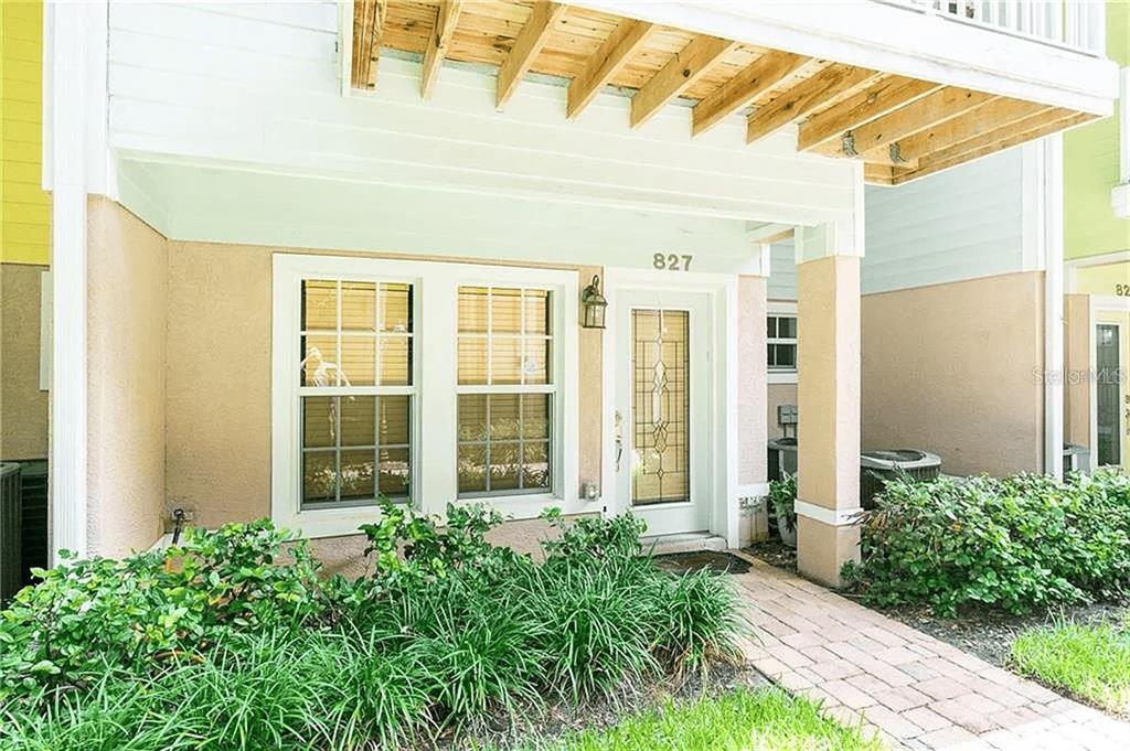 The exterior of a residential building features a covered entryway with a brick walkway — 827 GROVE STREET N, ST PETERSBURG, FL