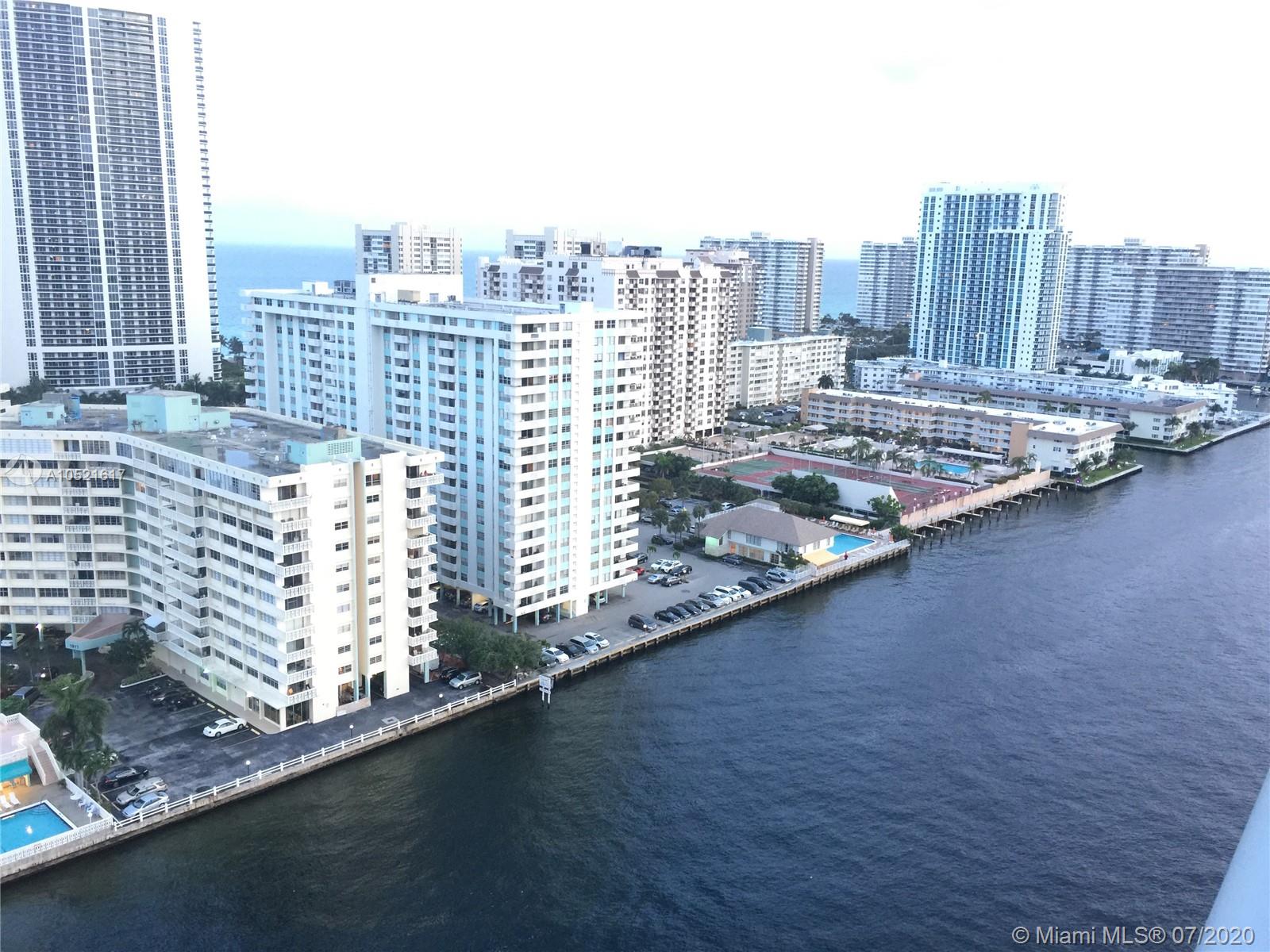An aerial view shows multiple high-rise residential buildings situated along a waterfront canal — 2600 E Hallandale Beach # 2202, Hallandale Beach FL 33009, HALLANDALE BEACH, FL