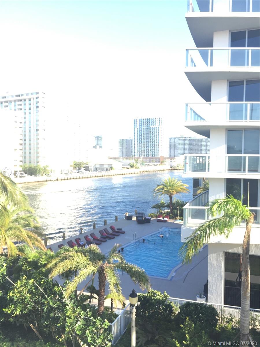 An elevated view of a swimming pool and deck area overlooking a waterway and buildings — 2600 E Hallandale Beach # 2202, Hallandale Beach FL 33009, HALLANDALE BEACH, FL