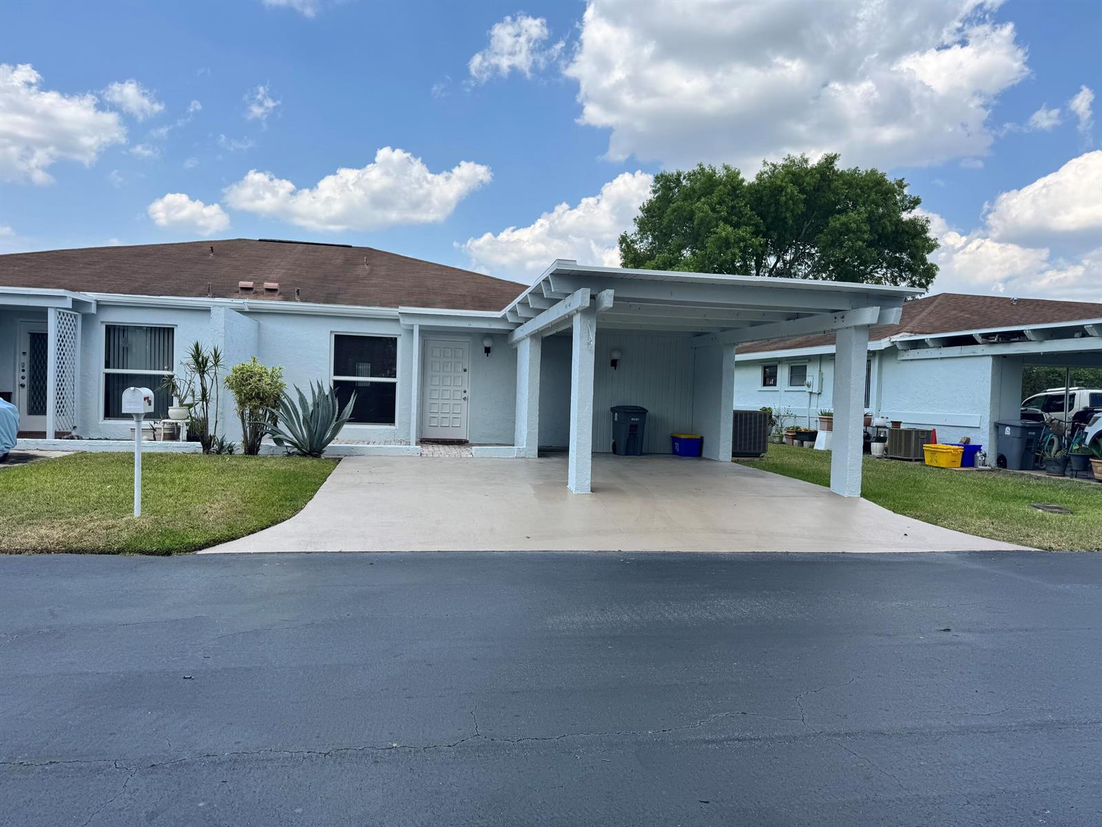 A single-story house with a white stucco exterior, a carport, and a paved driveway — 6846 Moonlit Drive, Delray Beach FL 33446, DELRAY BEACH, FL