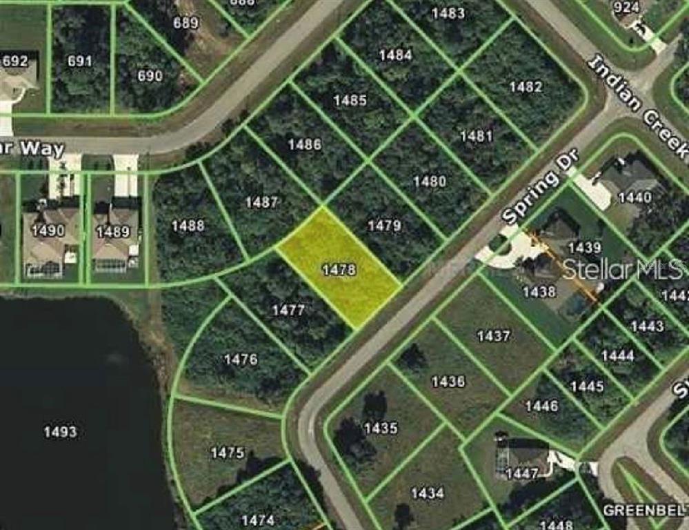 This is an aerial map showing a highlighted residential lot among surrounding undeveloped wooded parcels — 232 SPRING DRIVE, ROTONDA WEST, FL