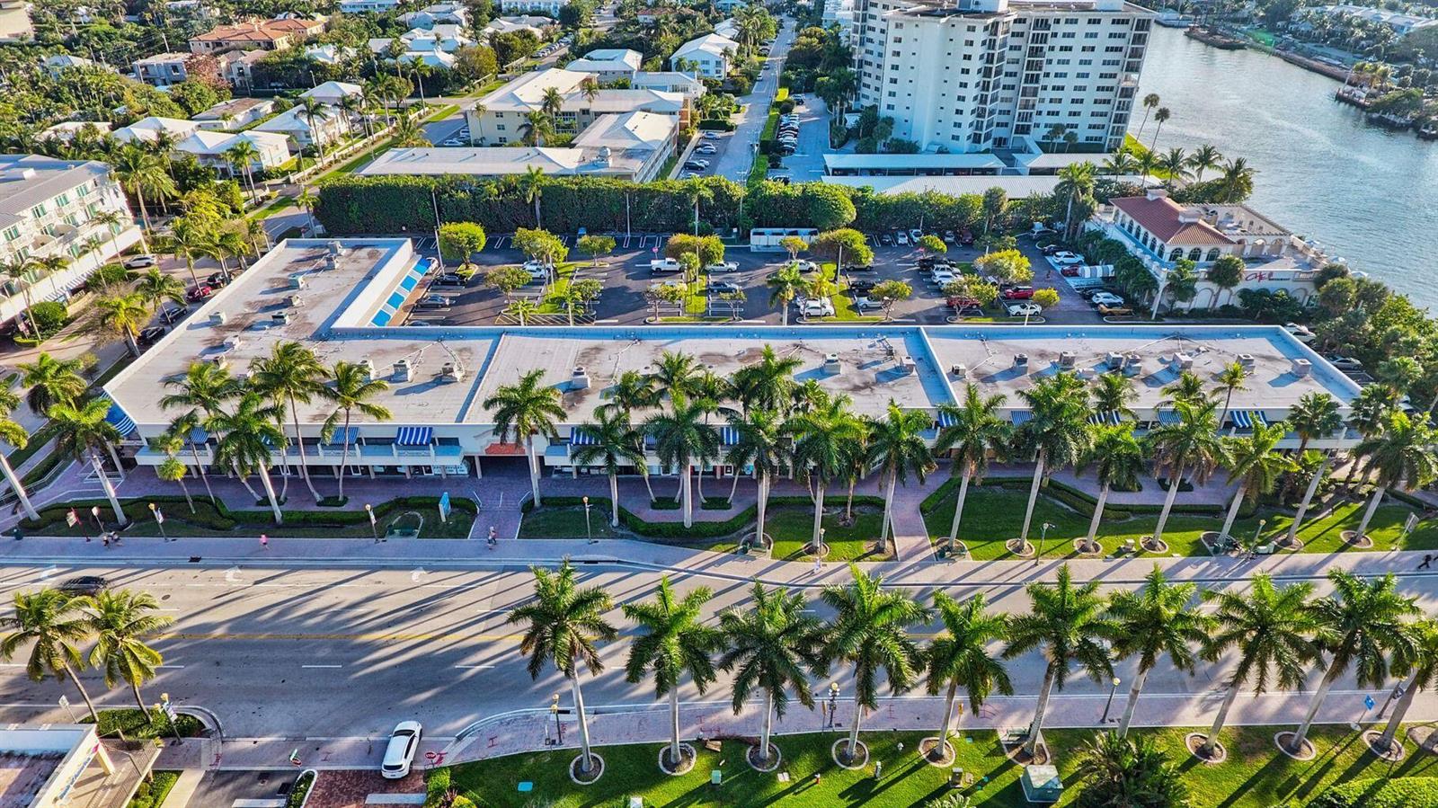An aerial view shows a commercial building with a flat roof and palm-lined parking lot — 900 E Atlantic Avenue # 12, Delray Beach FL 33483, DELRAY BEACH, FL