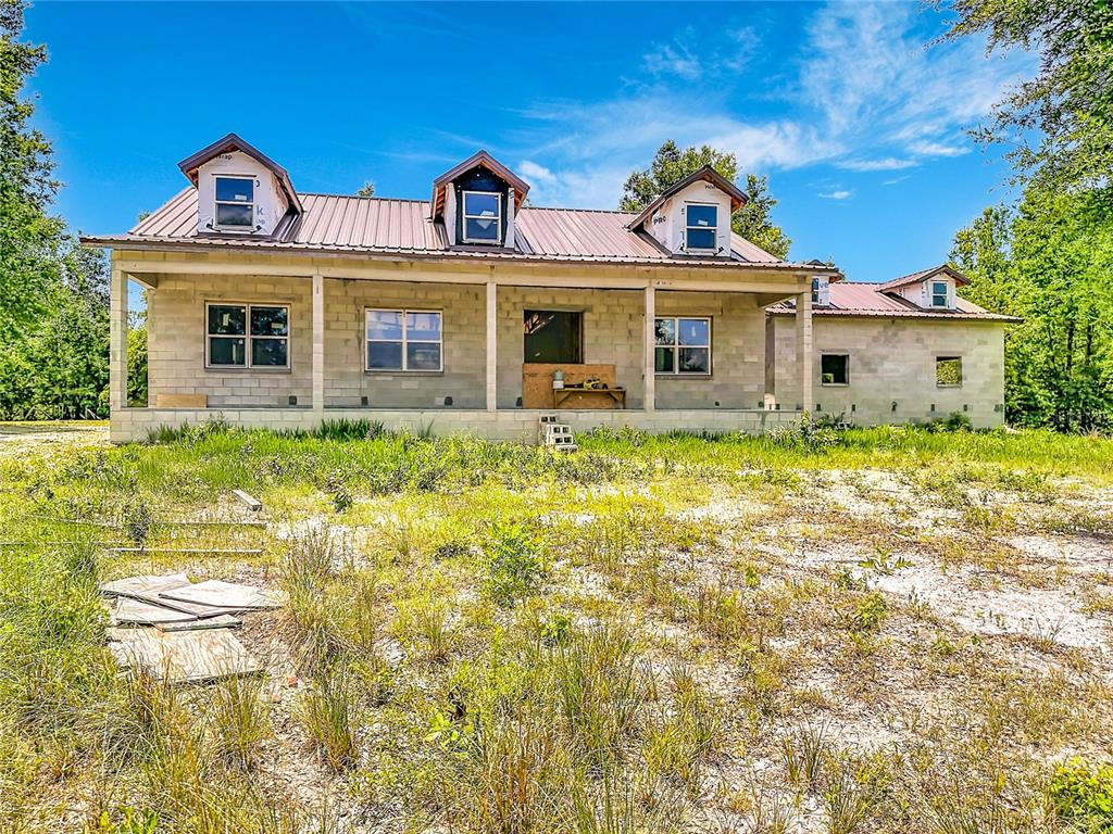 A partially constructed single-story house with a metal roof and concrete block exterior walls — 2916 SW ICHETUCKNEE AVENUE, LAKE CITY, FL