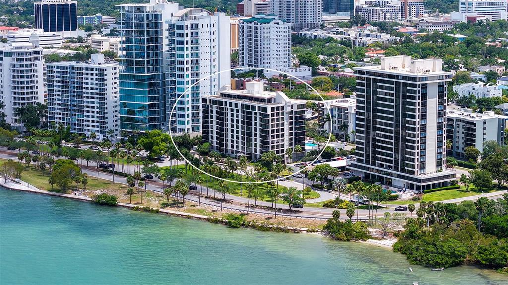An aerial view of a waterfront city skyline featuring sailboats on the bay — 707 S GULFSTREAM AVENUE UNIT 307, SARASOTA, FL