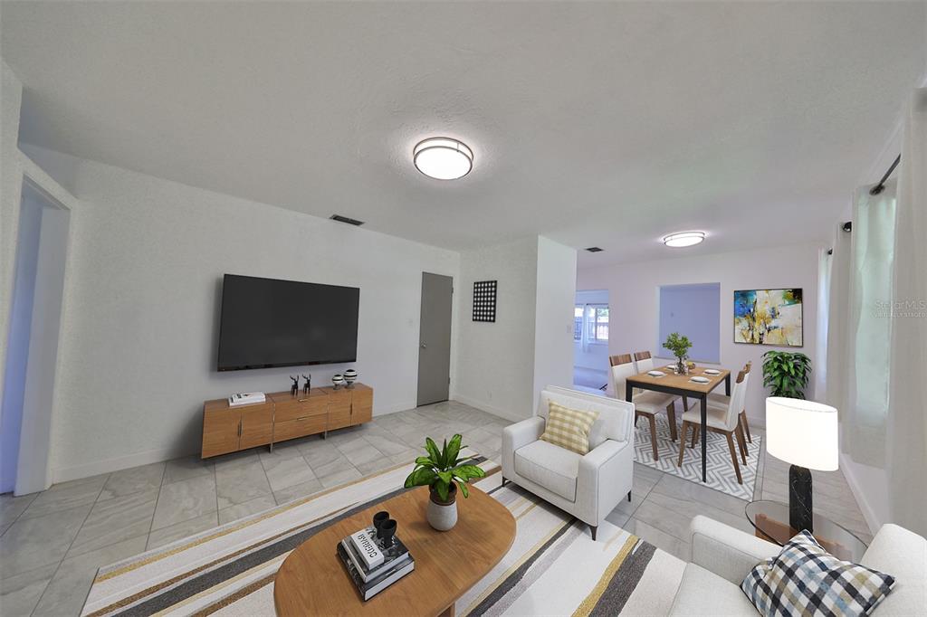 A living and dining room with white walls, tile floors, and a mounted television — 3908 W WALLACE AVENUE, TAMPA, FL